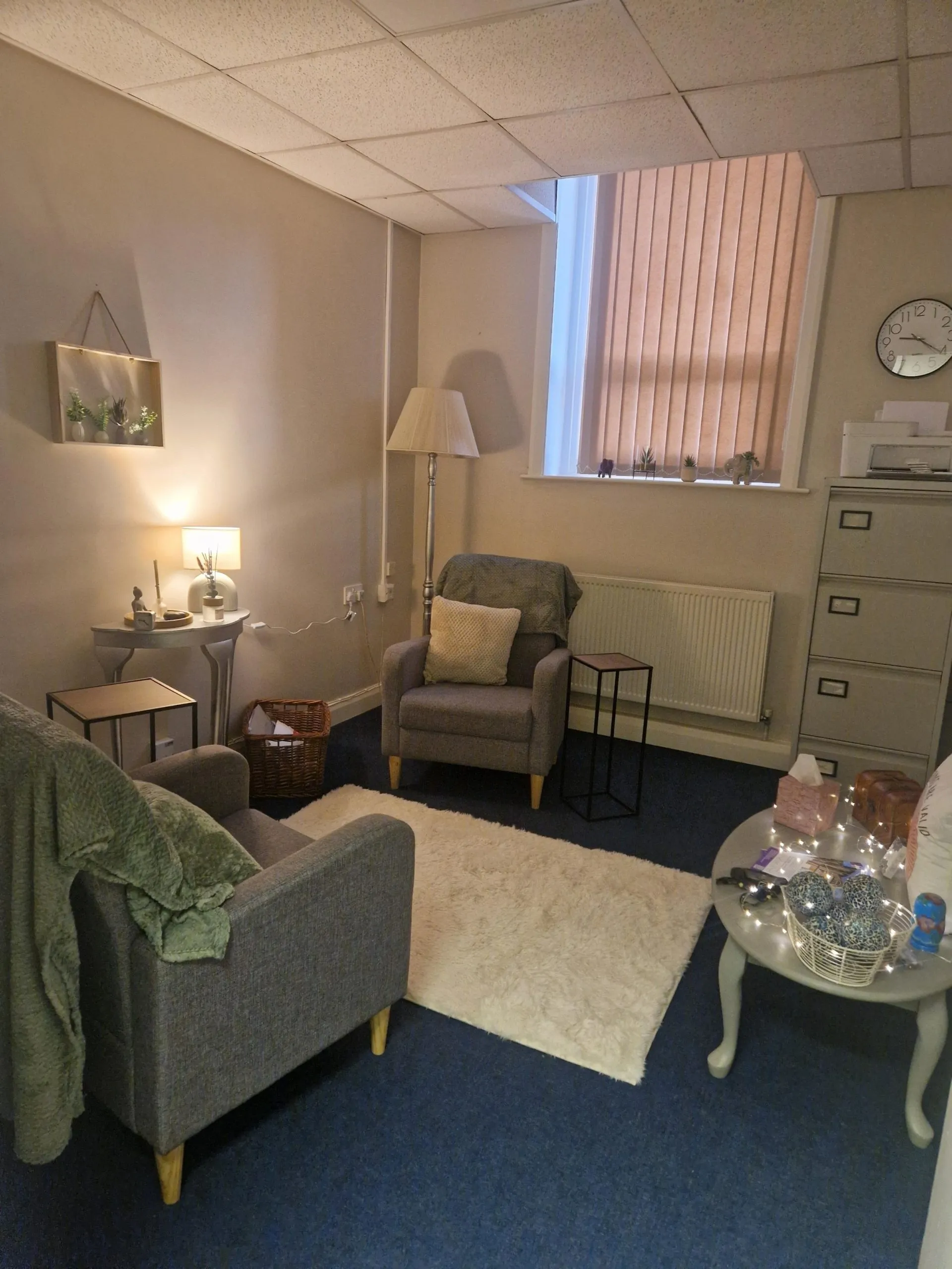 A calm counselling room with two armchairs